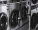 A grayscale shot of a washing machine with opened doors